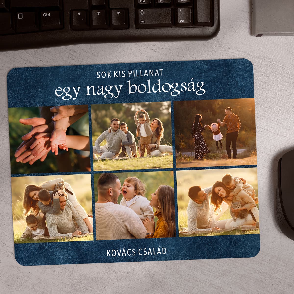 Családi fényképes egérpad 6 képpel, sötétkék háttérrel és „Sok kis pillanat, egy nagy boldogság” felirattal, billentyűzet mellett